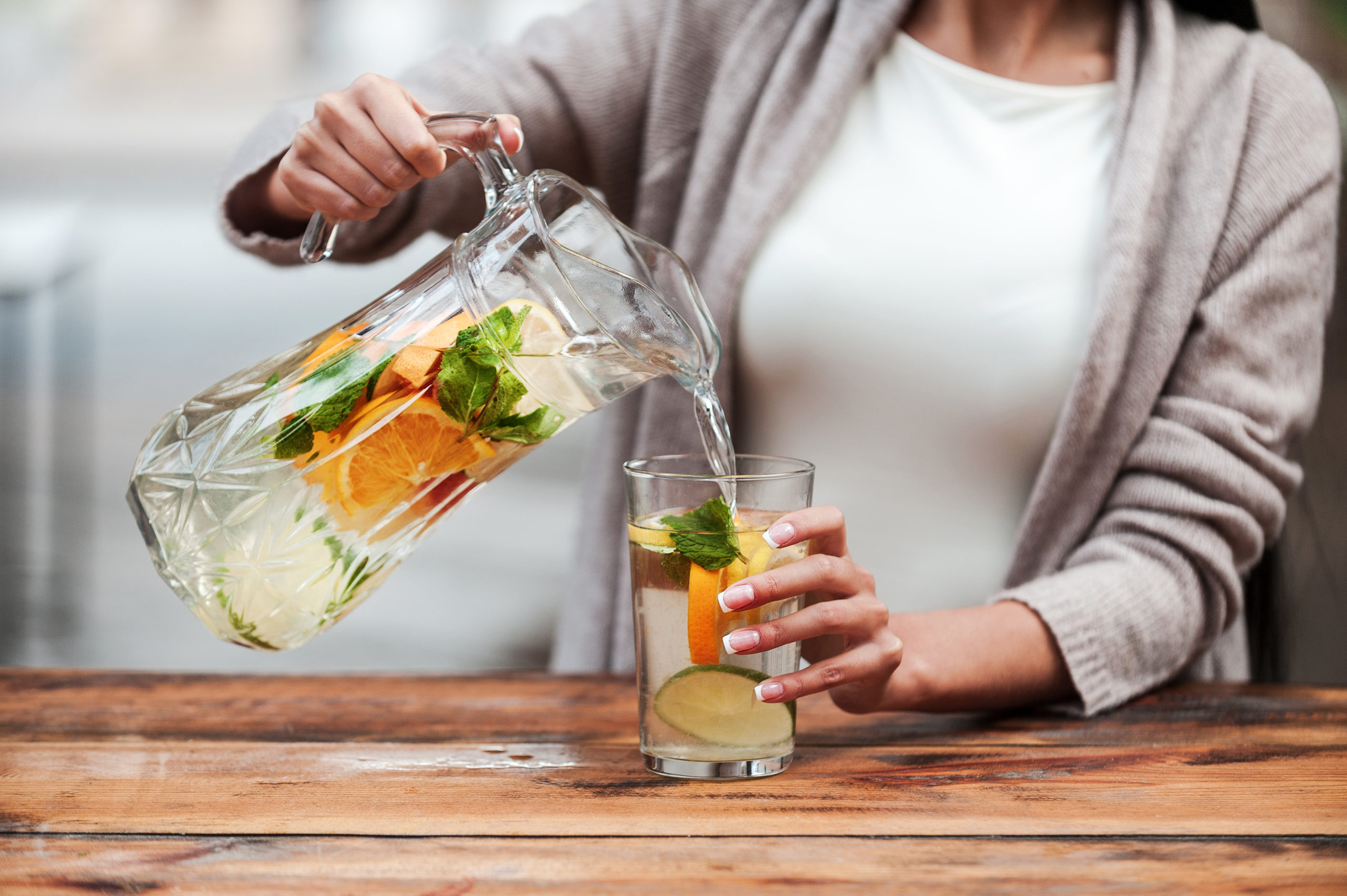 woman pouring detox water